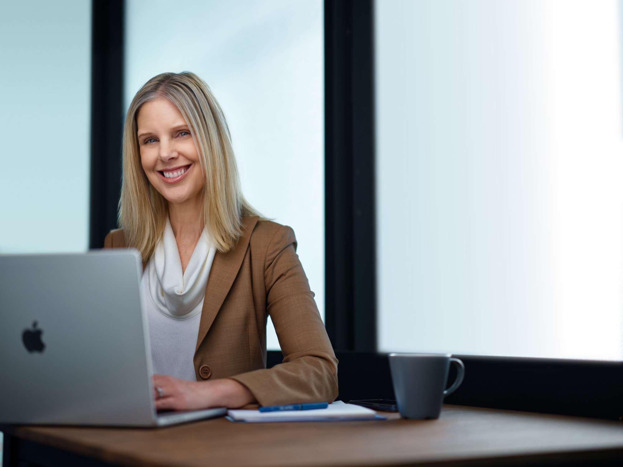 Michelle Richard, founder of ExpressBrand Studio, working at a laptop